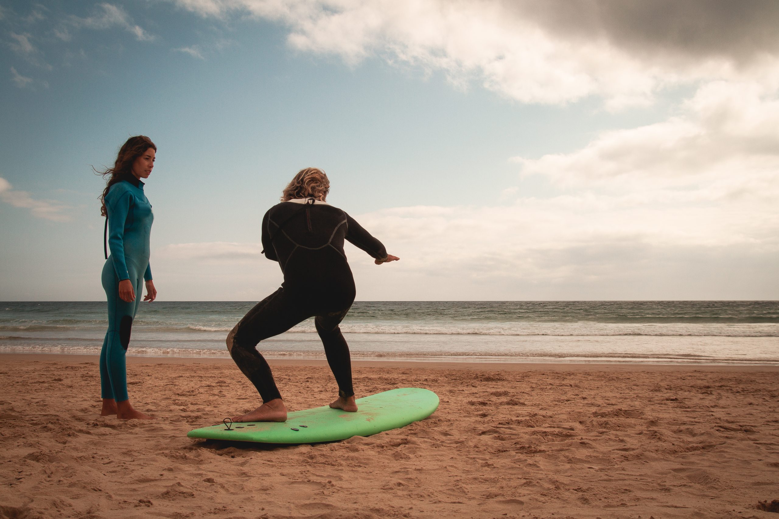 Surfer girl taking a surf lesson and going to the beach