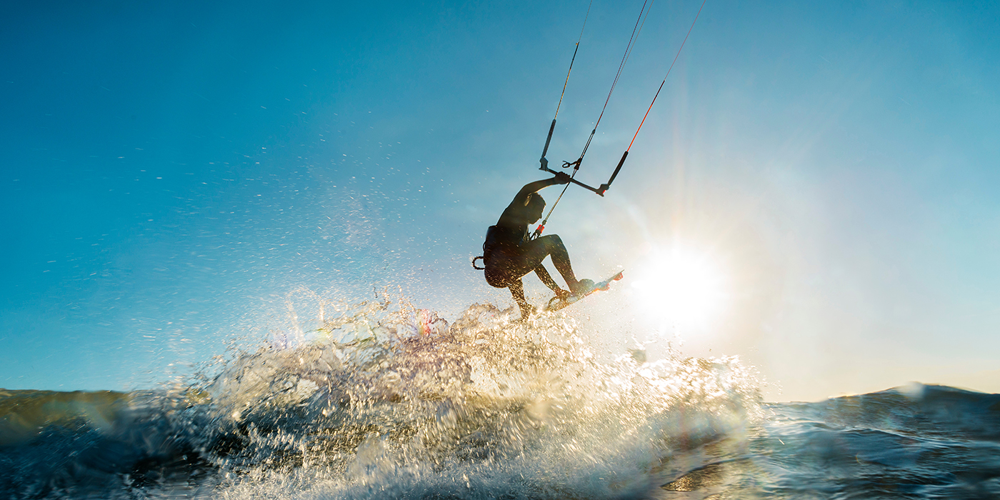 Surfer jumping at the sunset