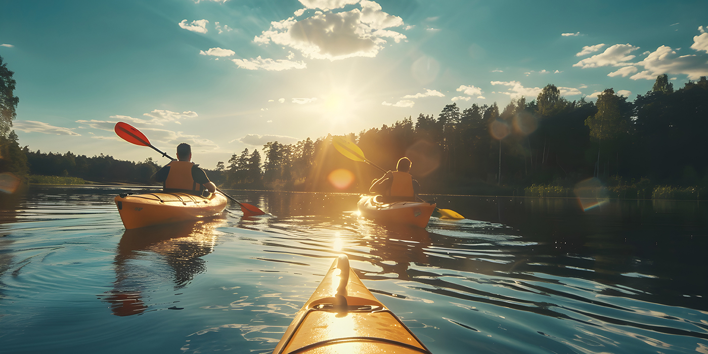 Serene sunlit kayaking adventure: Paddling through a calm lake with style and grace.