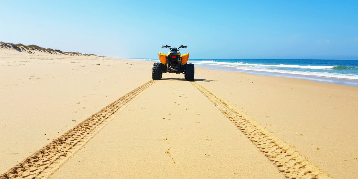 Yellow ATV on a sandy beach
